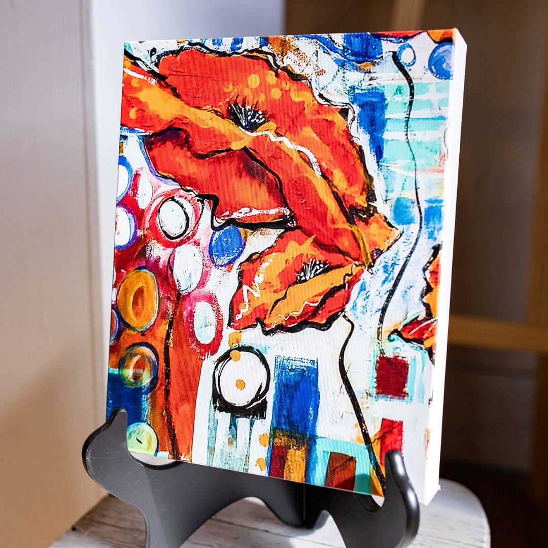 a piece of urban life poppy canvas print on a stand